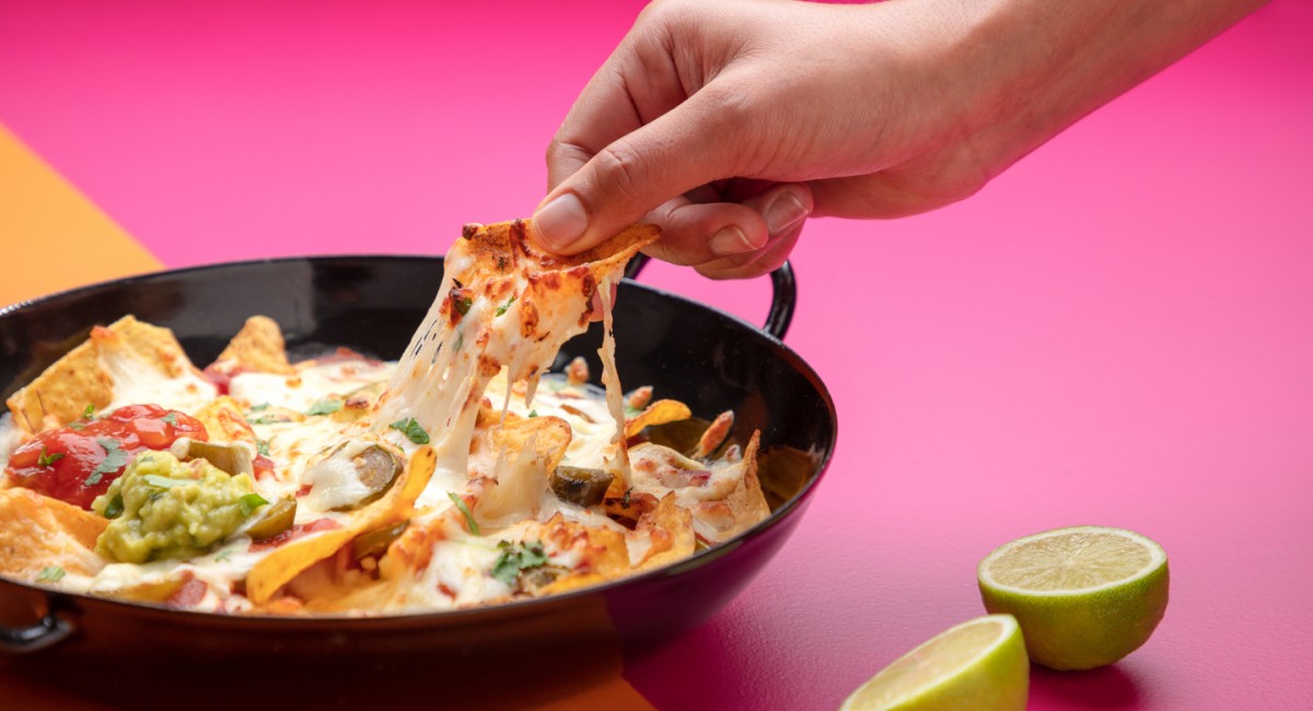 A bowl of cheese covered nachos