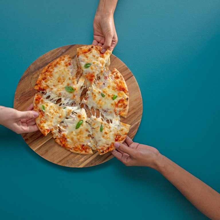 Three hands taking slices of cheese pizza from a board